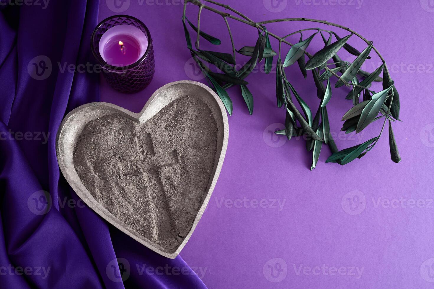 Lenten Symbols. A heart-shaped dish with ashes, a candle, and a branch photo