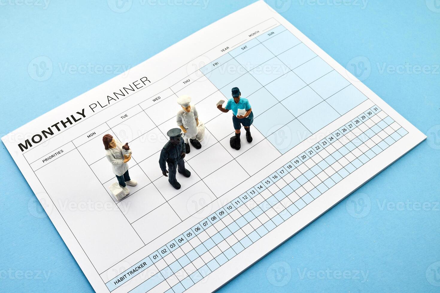 Concept of four-day work week. Printed calendar for a 4 day working week. Mini Figures on Planner photo