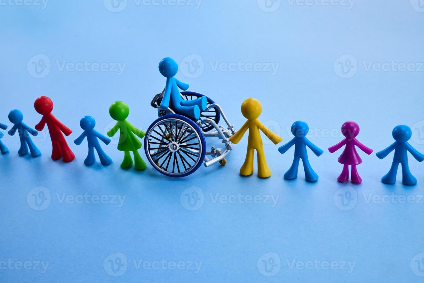 Inclusivity. Colorful figures holding hands with one in a wheelchair, symbolizing inclusion. photo