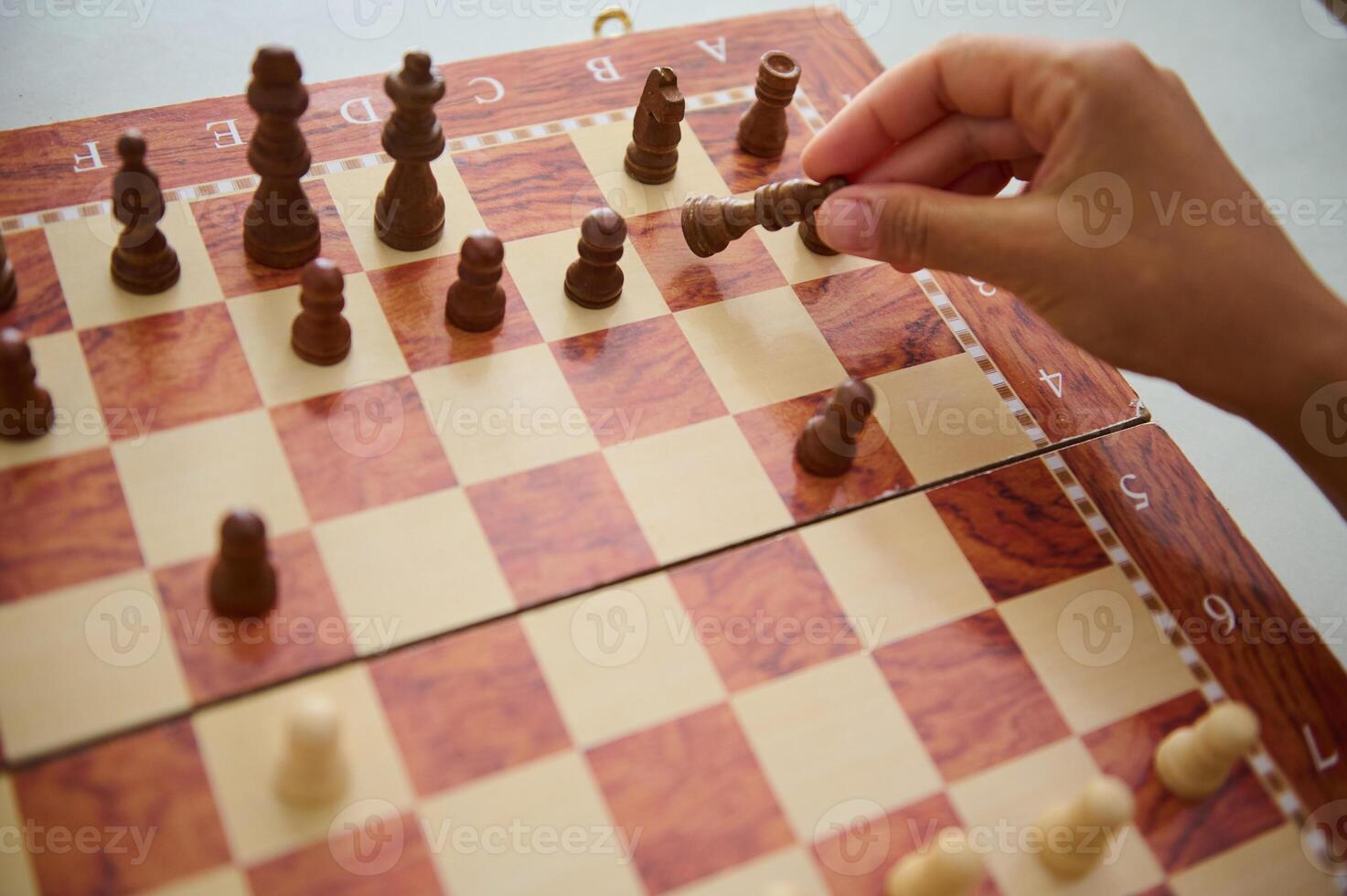 Person engaging in an intense strategic chess match photo