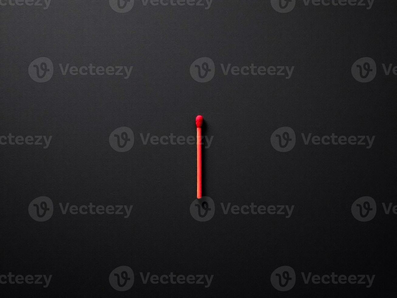 Red matchstick on black background with copy space. Top view. photo