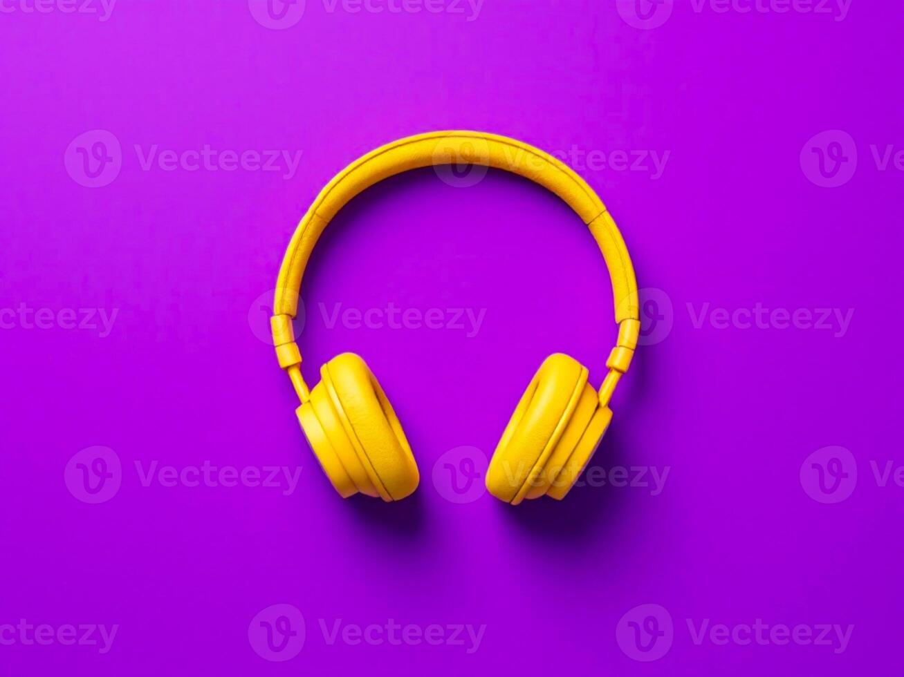 Yellow headphones on purple background. Top view. Minimal style. photo