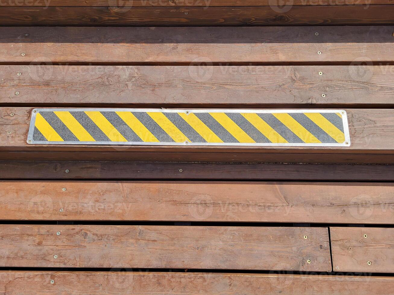 Wooden steps with anti-slip pads. A stripe for marking dangerous areas. photo