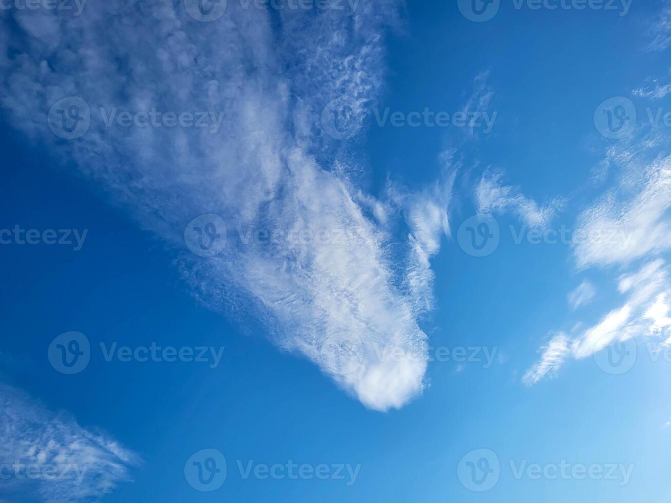 On a bright sunny day, the blue sky with a white cloud like a comet photo
