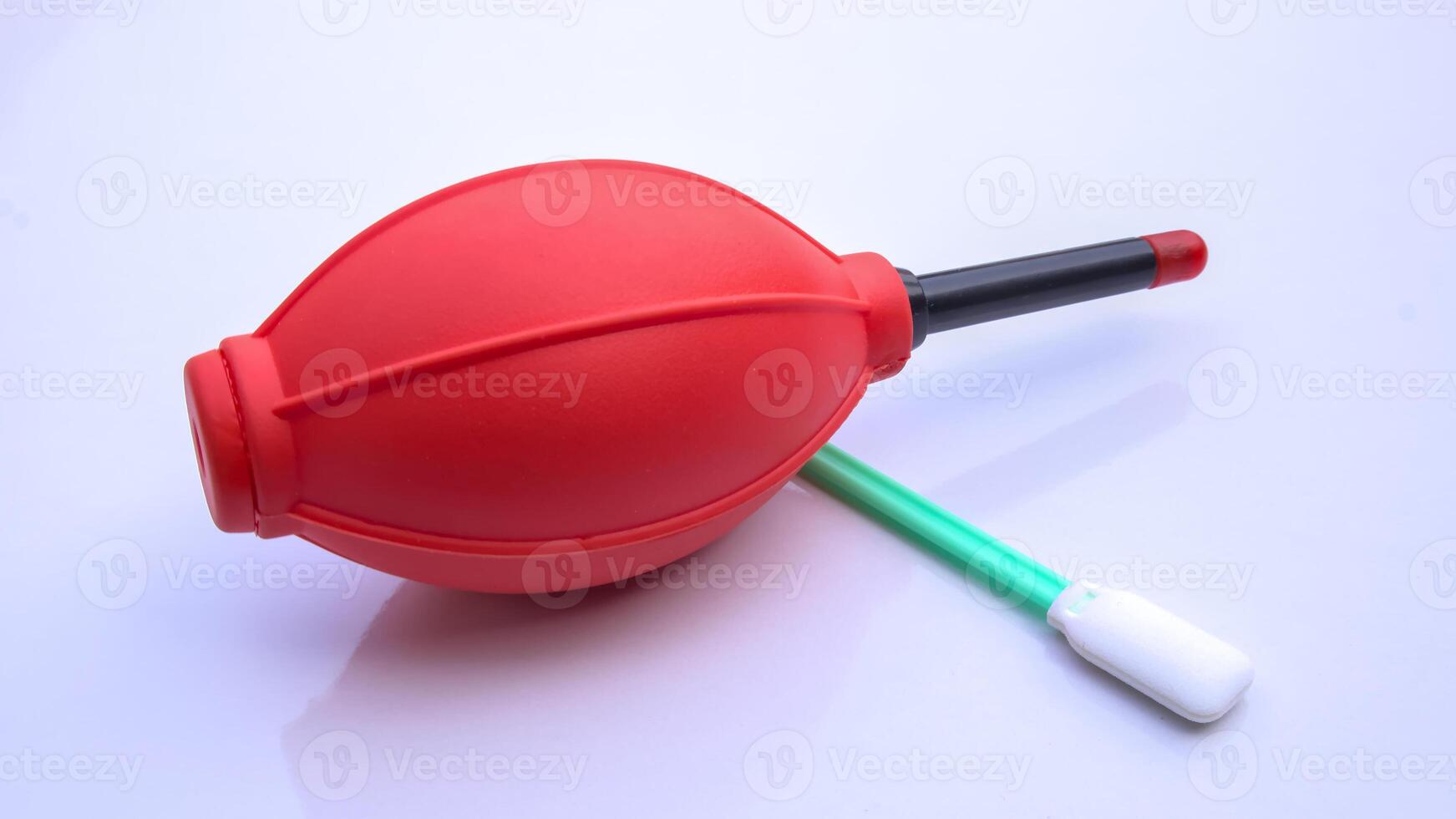 Camera Cleaning Kit Air Blower and Swab, Red Rubber Air Blower, Dust Cleaner Isolated, White Background photo