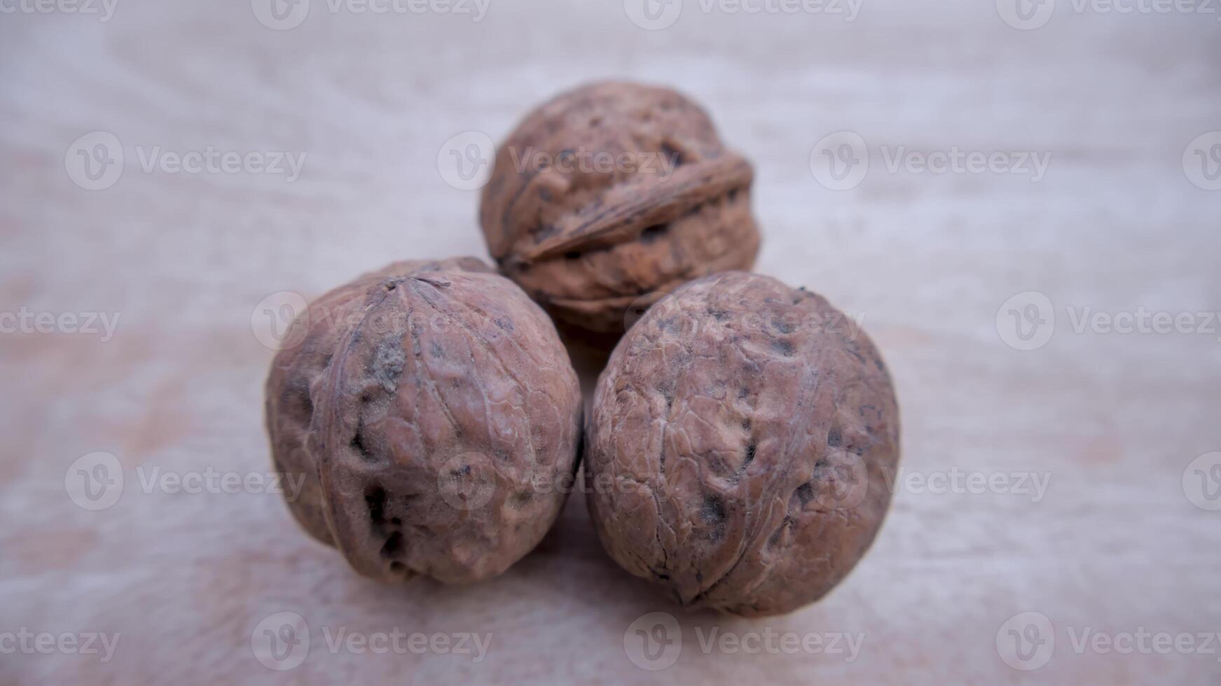 Three Desi Walnuts Isolated, Closeup, Neutral Background photo