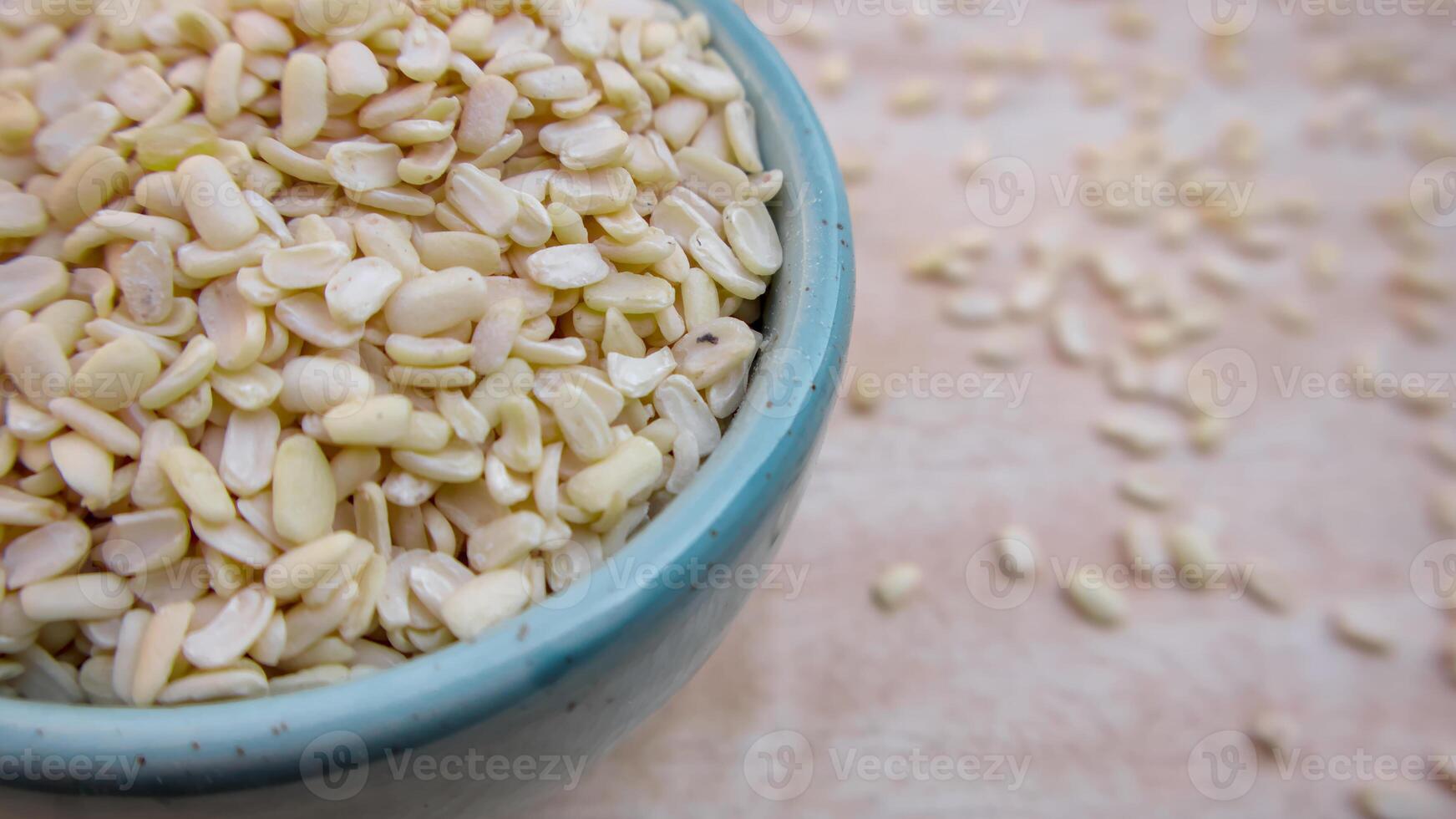 Split Dehusked Black Gram White Lentils in a Blue Bowl, Closeup photo