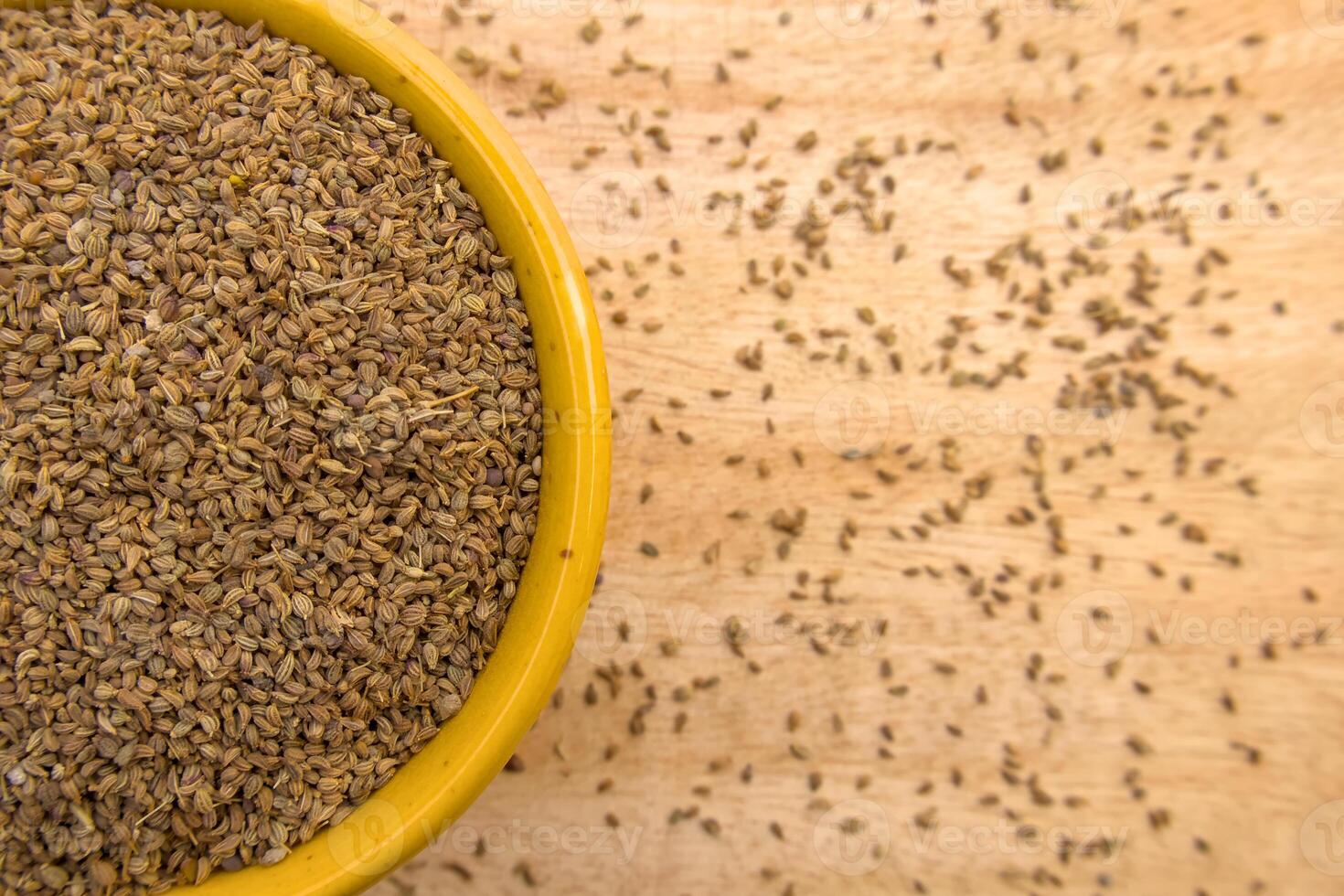 Top View of Ajwain, Carom Seeds, Thymol Seeds, Bishop's Weed in a Yellow Bowl, Closeup photo