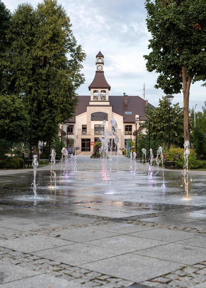 Mikhailowo, Poland, 08.18. 2024. Central city park, fountain, town hall photo