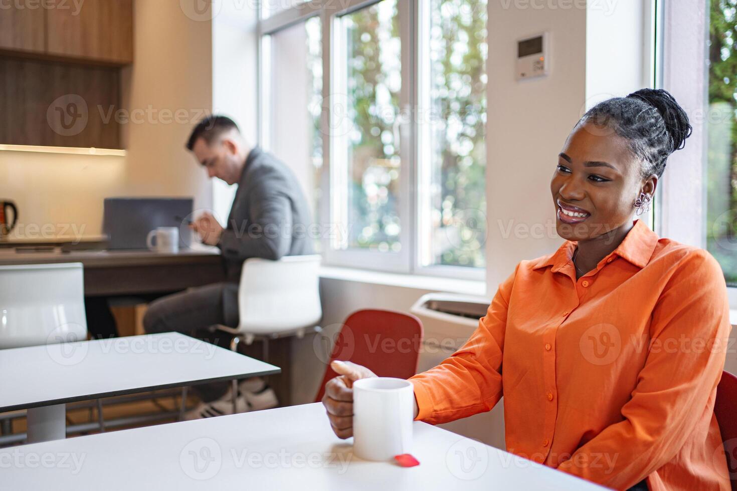 Woman Sitting at Table With Coffee Cup photo