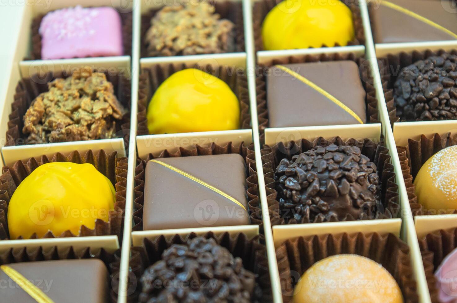 multi-colored chocolate and iced candies of different colors and shapes are neatly stacked in their places. High quality photo