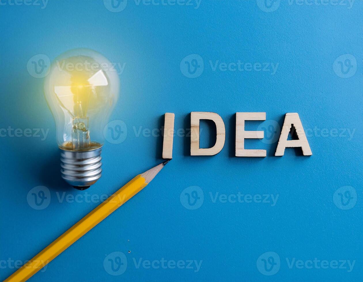 Pencil with Light Bulb and 'Idea' Word on Blue Background photo