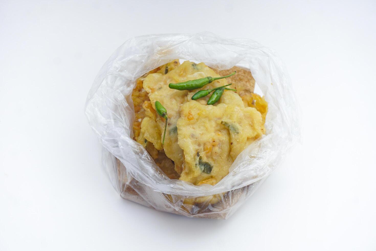 White Transparent Background Plastic Of Mendoan or Tempe Mendoan, Transparan background tempe mendoan dengan cabai hijau photo