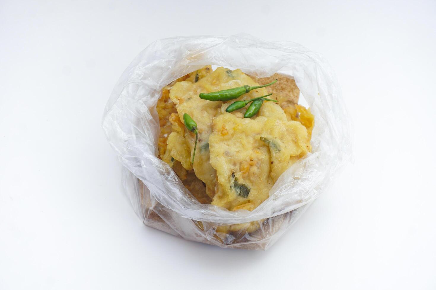 transparant white background fried mendoan with plastic bag gorengan mendoan di dalam tas plastik dengan cabai hijau photo