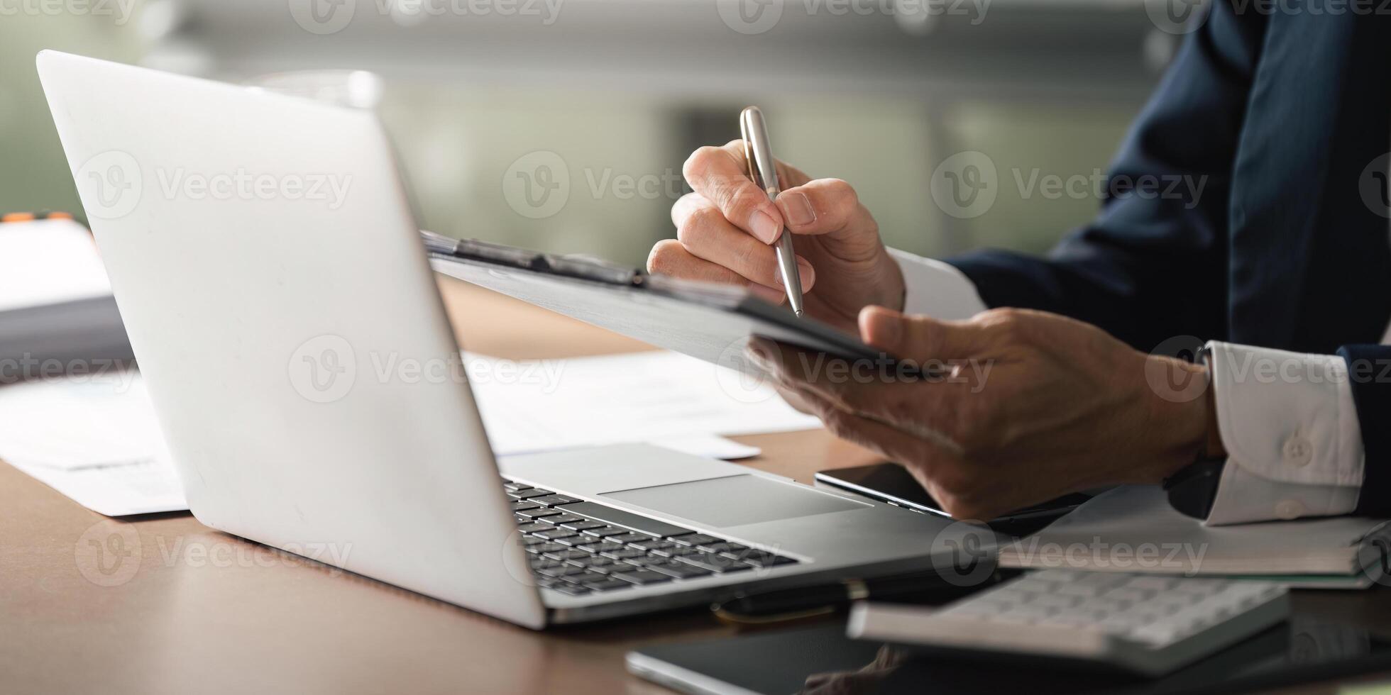 Elderly businessman engaged in digital work office environment professional setting close-up perspective productivity insights photo