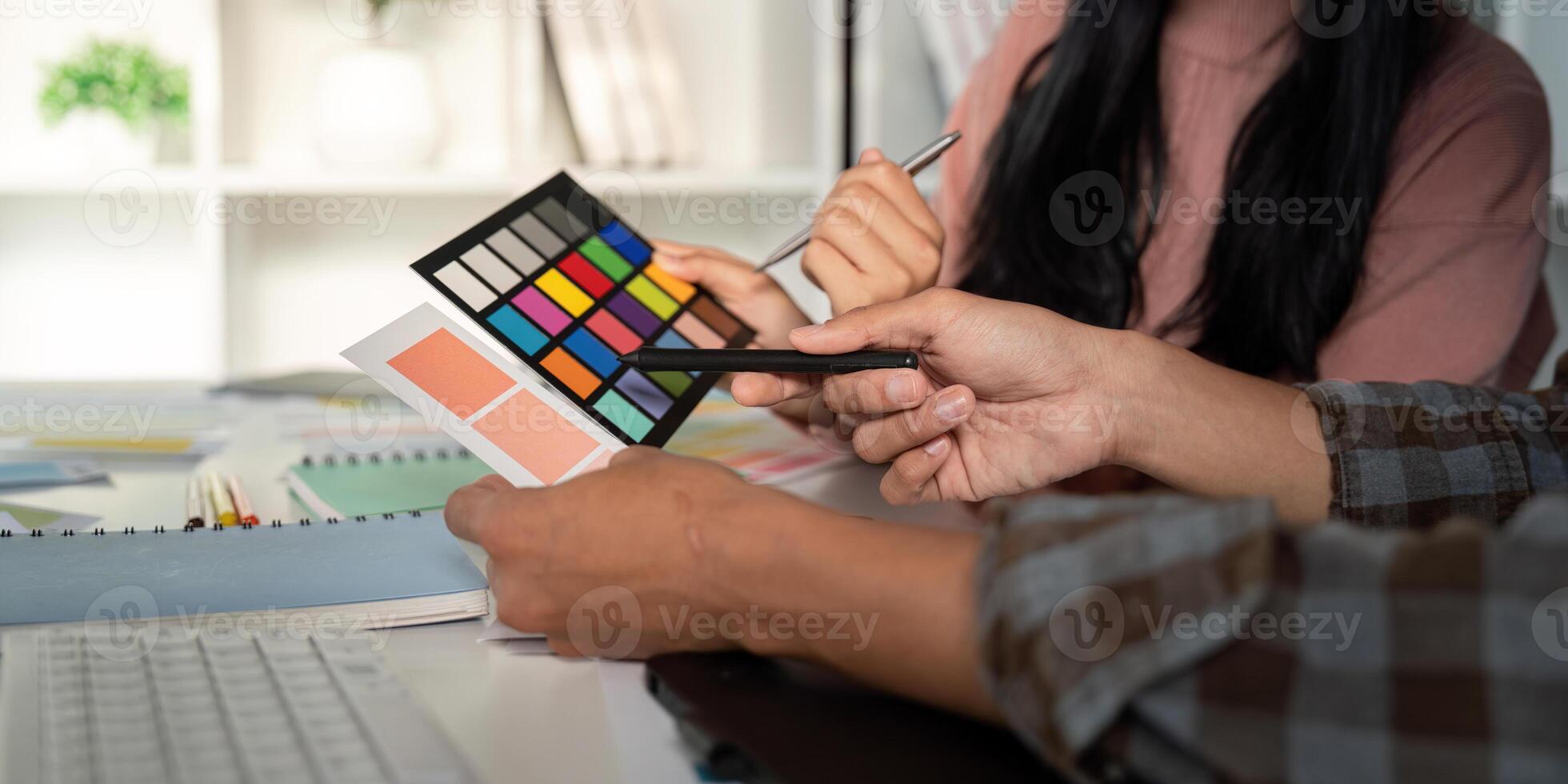 Diverse team evaluating color palettes for graphic design project. photo
