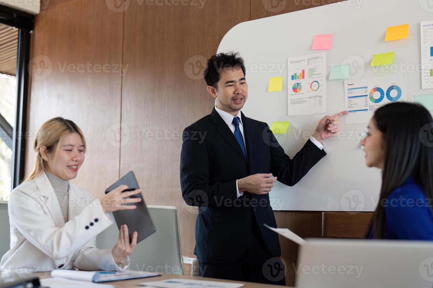 Diverse business team presenting financial analysis and insights in a modern office environment. photo