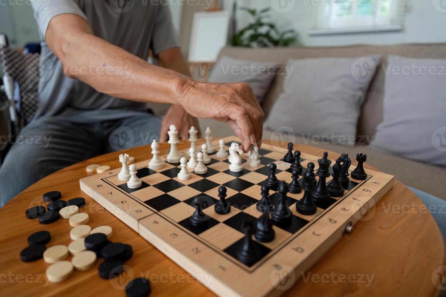 Father making a strategic move in chess game against his son. photo