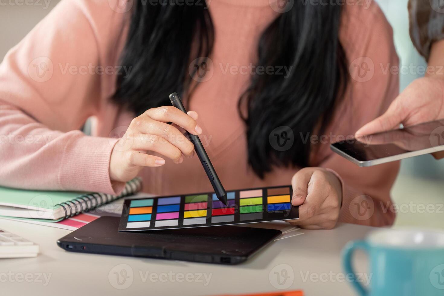 Diverse team member selecting colors for graphic design project. photo