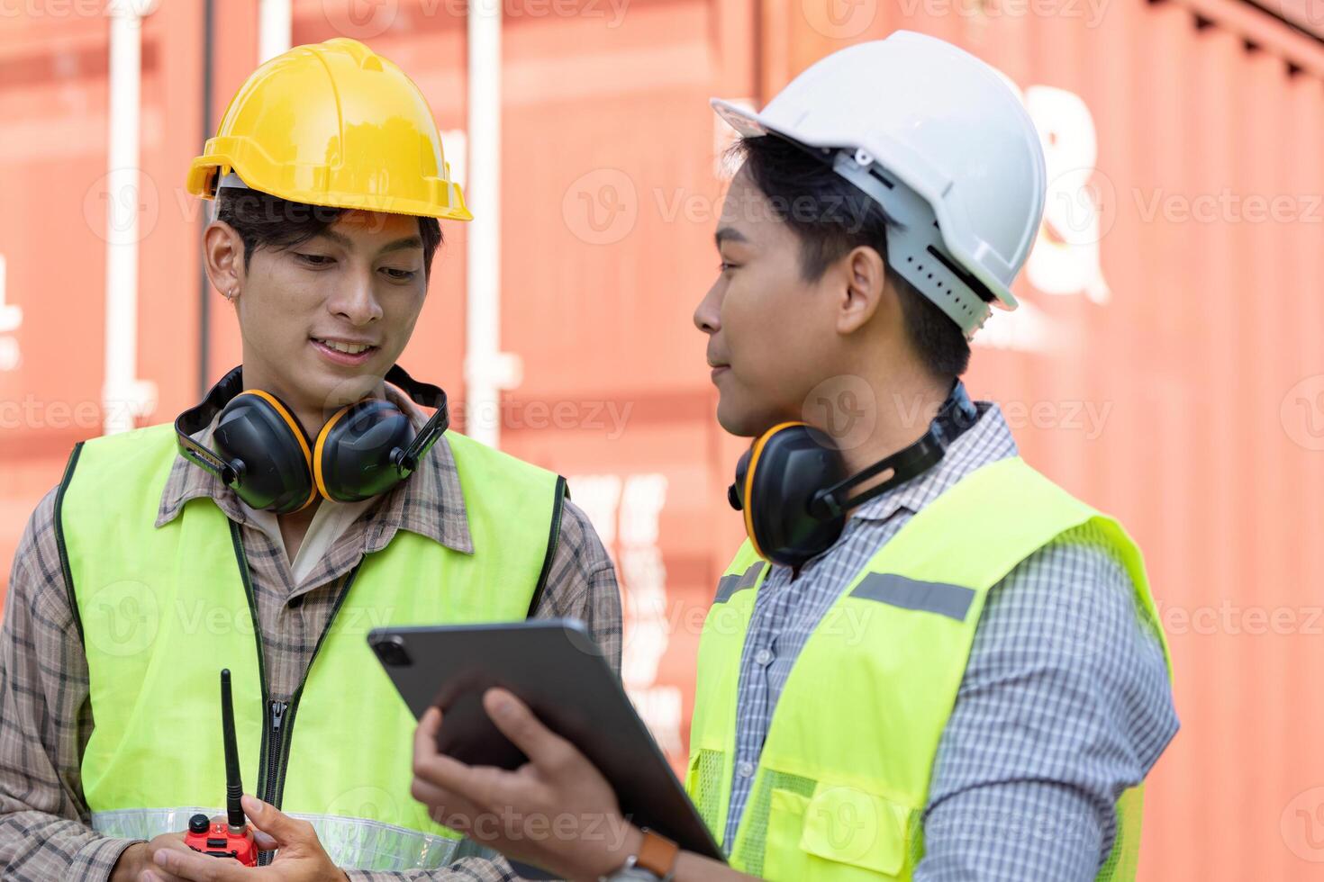 Logistics engineers collaborate on container management warehouse facility image professional environment close-up efficiency concept photo