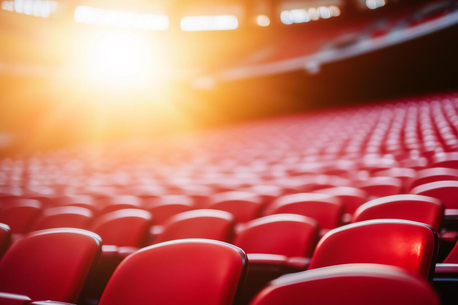 Colorful Rows of Plastic Seats Illuminated by the Sun in an Empty Stadium Arena photo