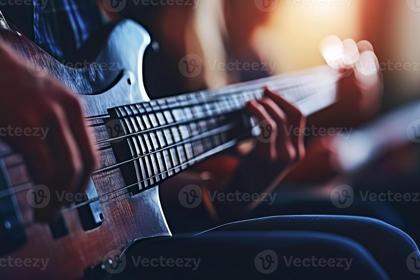 Close-Up of a Bass Guitar Player Hands While Playing in a Softly Lit Environment photo