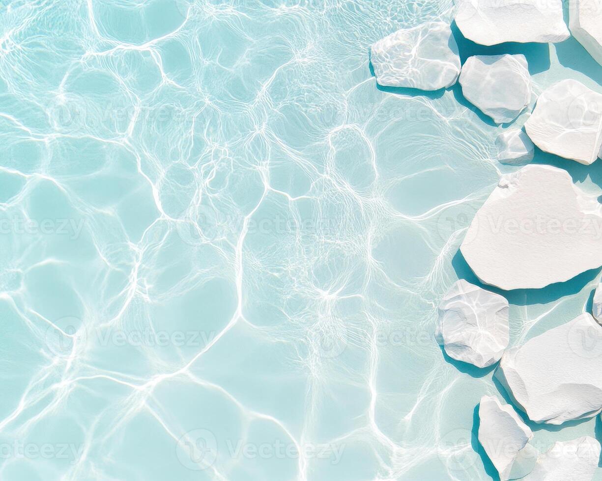 Crystal clear swimming pool water with white stones creating serene atmosphere. gentle ripples and reflections enhance tranquil beauty of scene photo