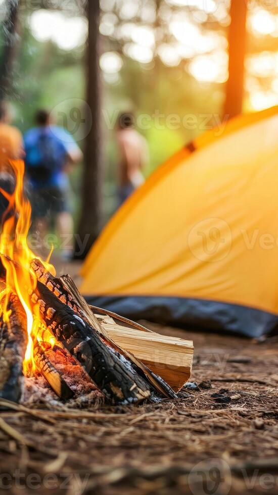 Cozy family camping in forest with warm campfire and yellow tent. Friends gather around, enjoying nature and creating lasting memories photo