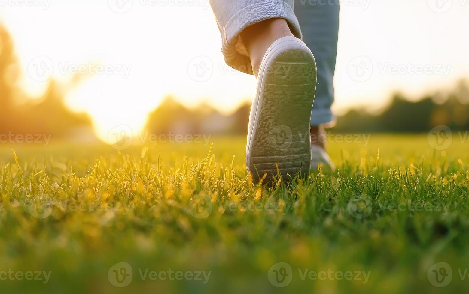 Walking on grass during sunrise, capturing serene moment of connection with nature. soft light enhances peaceful atmosphere, inviting tranquility and reflection photo