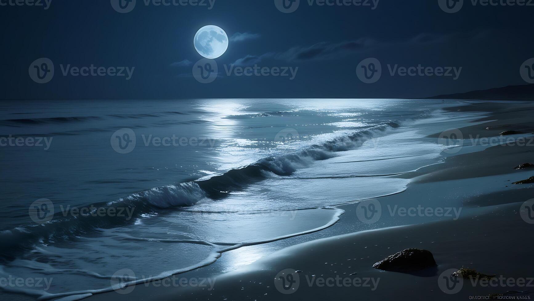 The ocean waves gently crashing on the shore under the glow of moonlight photo