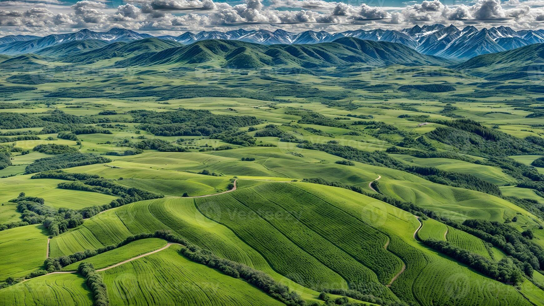 Aerial view of green rolling hills and mountains photo
