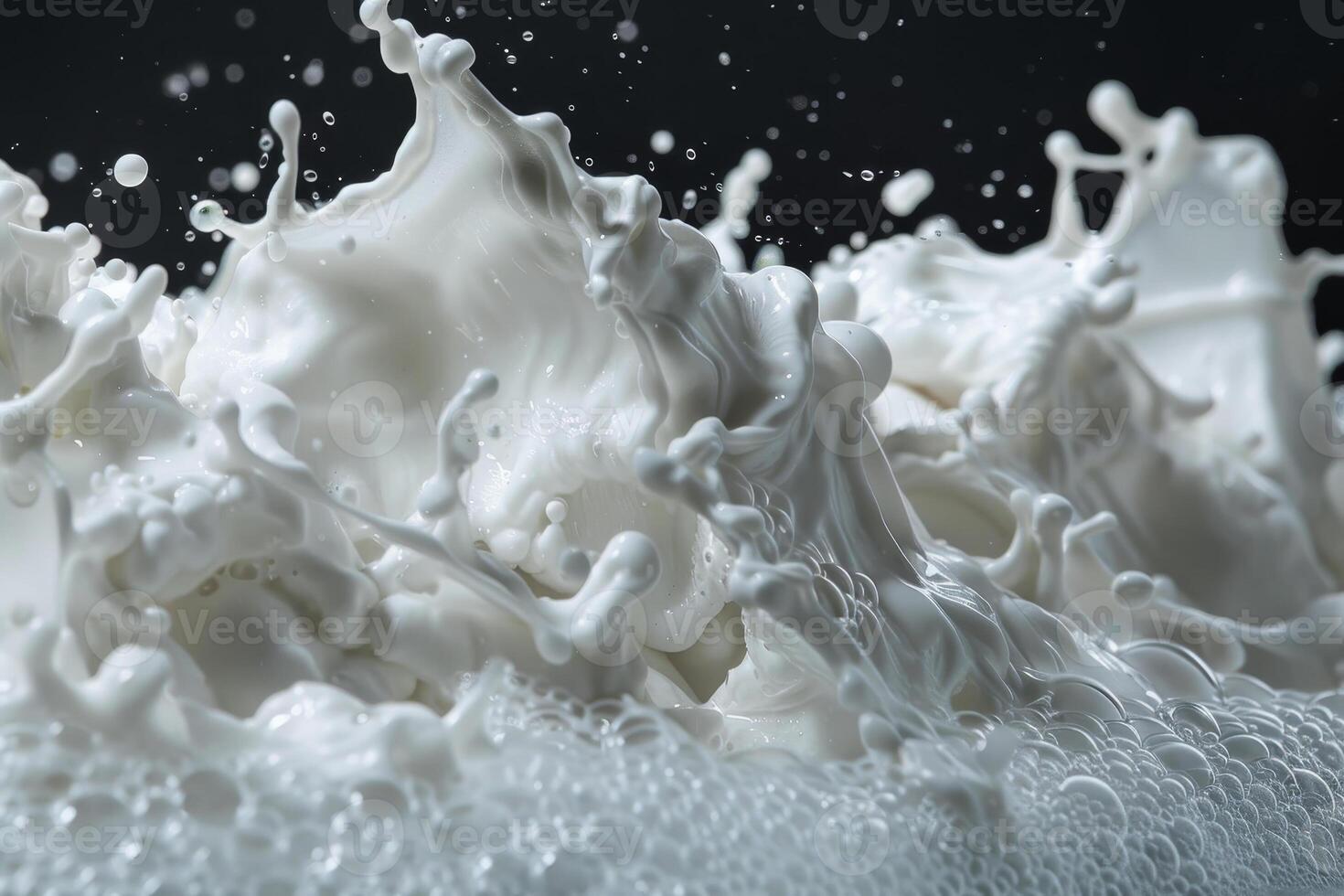 Milk is splashing dramatically, creating intricate patterns and bubbles against a contrasting dark background, highlighting the movement and texture of the liquid photo