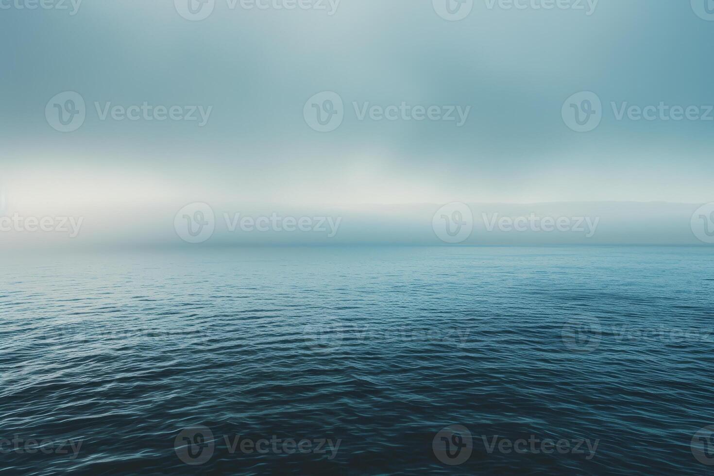 A view of the ocean from above with a foggy sky photo
