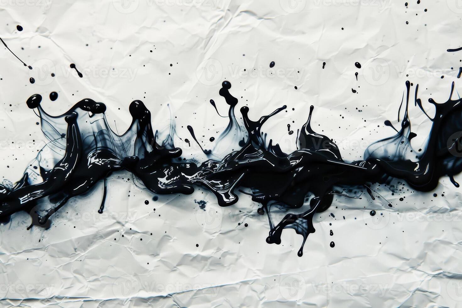 A black and white photo of ink splashing on a piece of paper