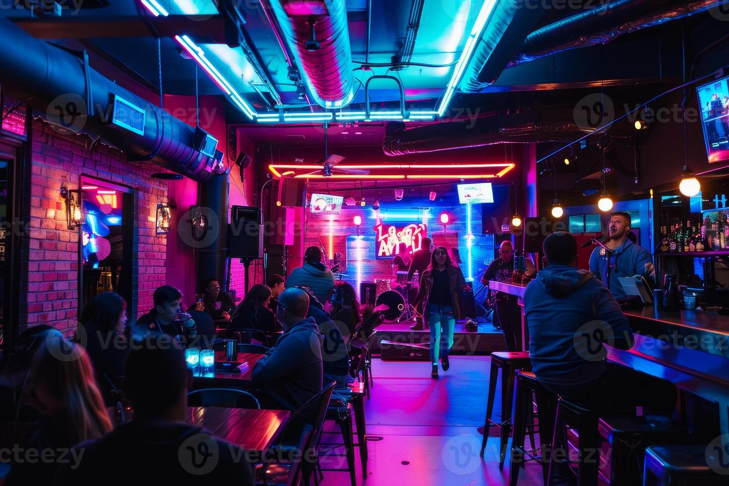 A neon bar with people sitting at tables and a stage photo