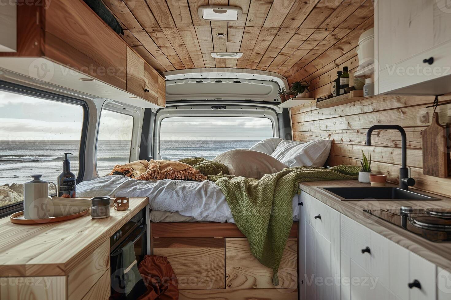 A camper van with a bed and sink in the middle of it photo