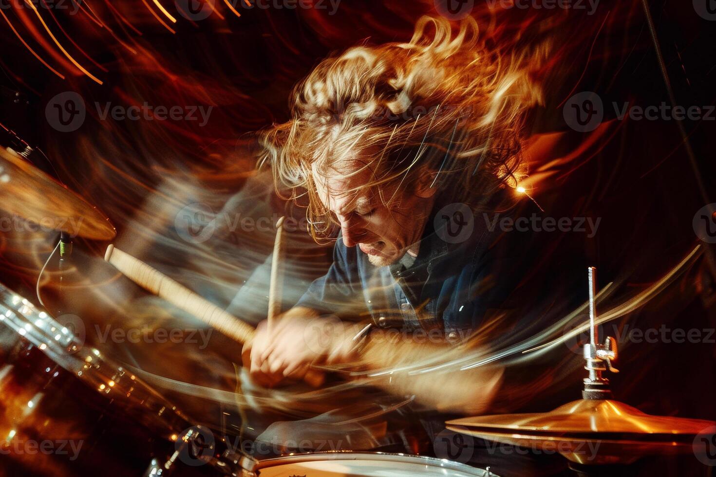 A man playing drums with a blurry background photo