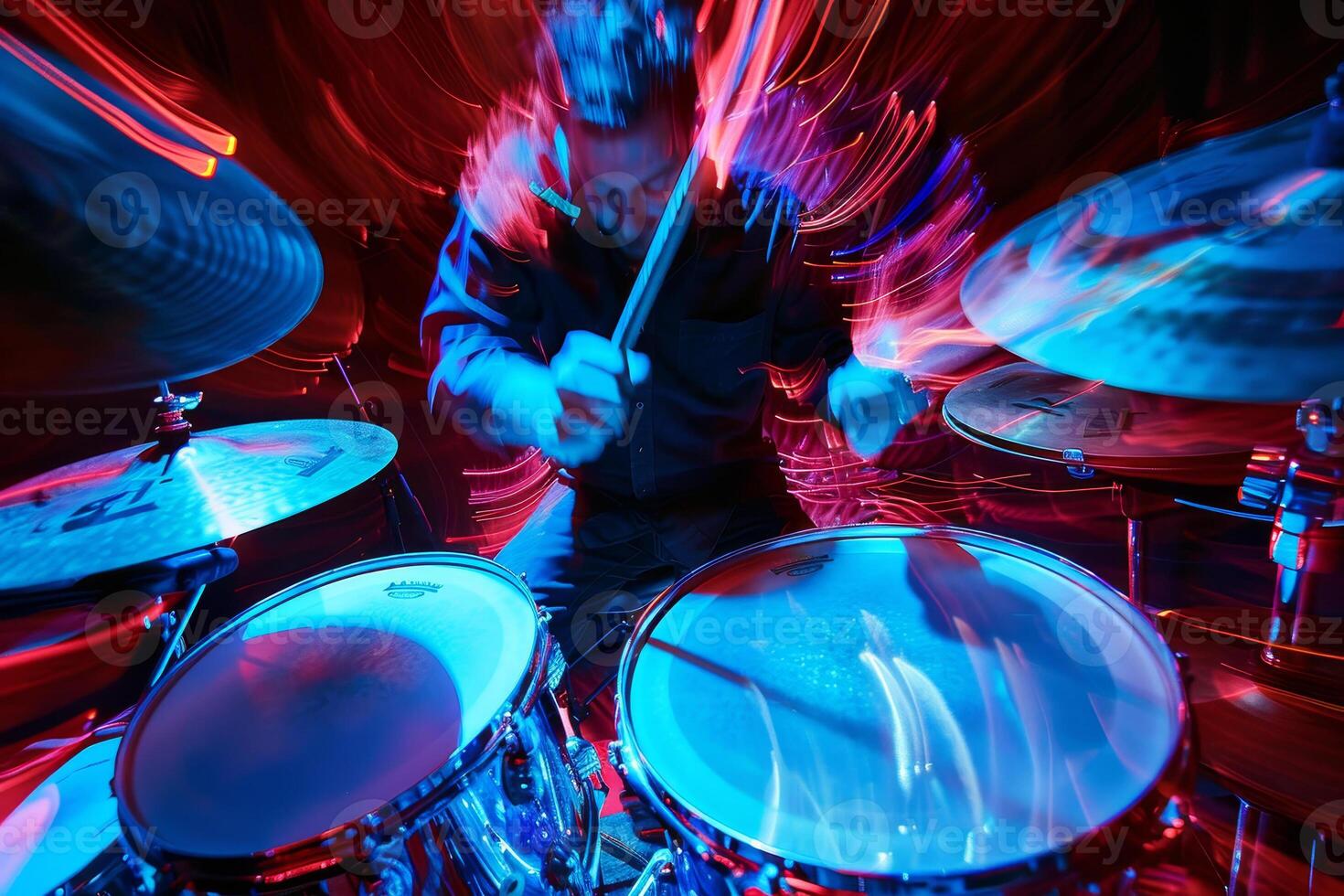 A man playing drums in a dark room photo