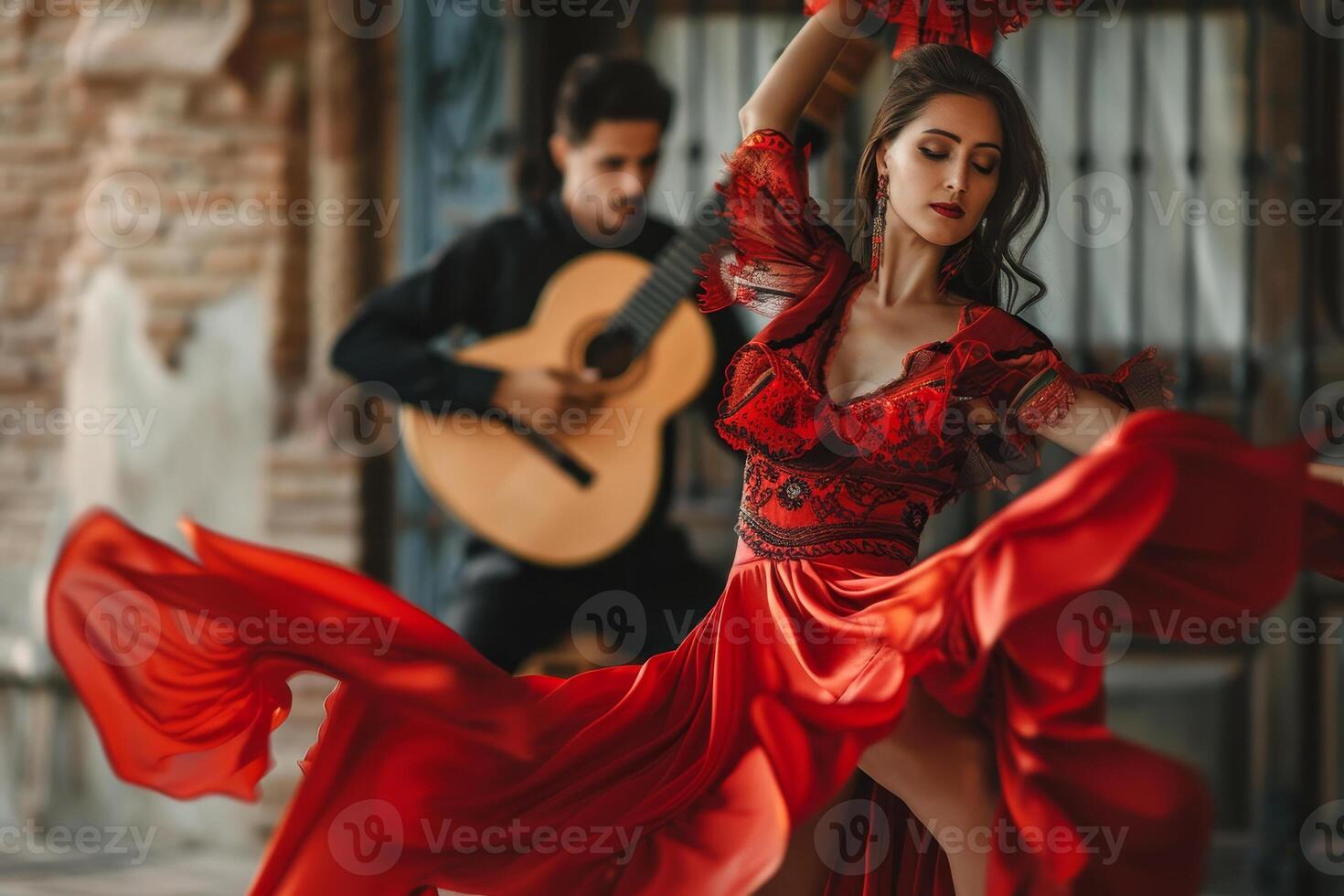 A woman in a red dress and a man playing a guitar photo