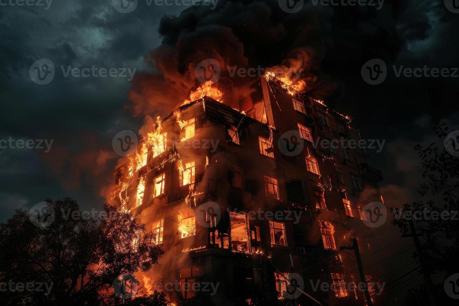 A burning building is shown in the dark photo
