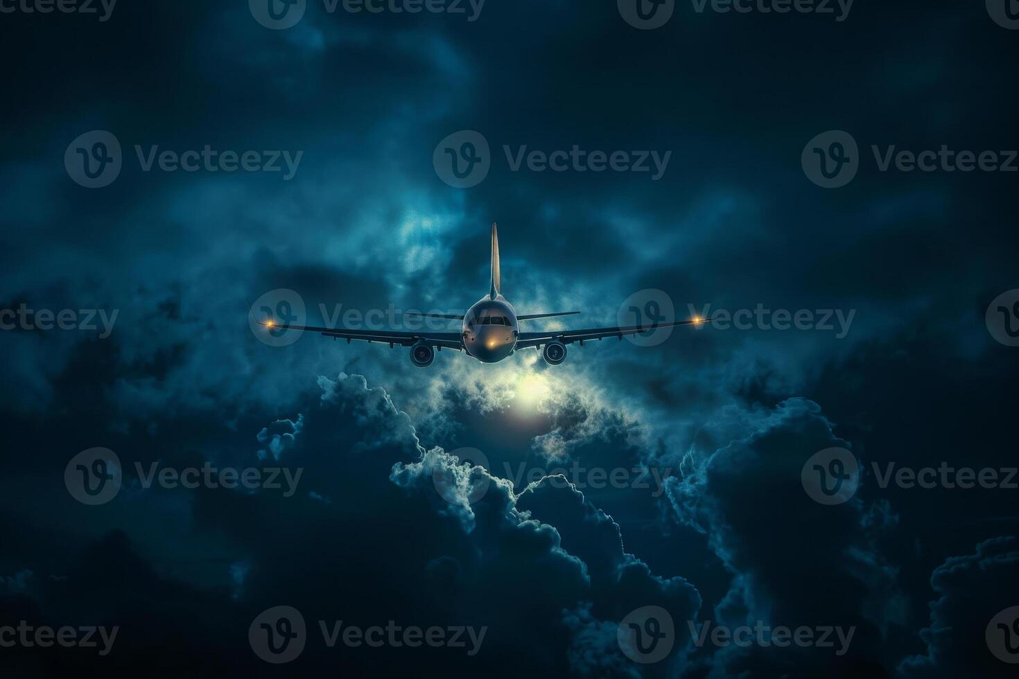 An airplane flying through the clouds at night photo