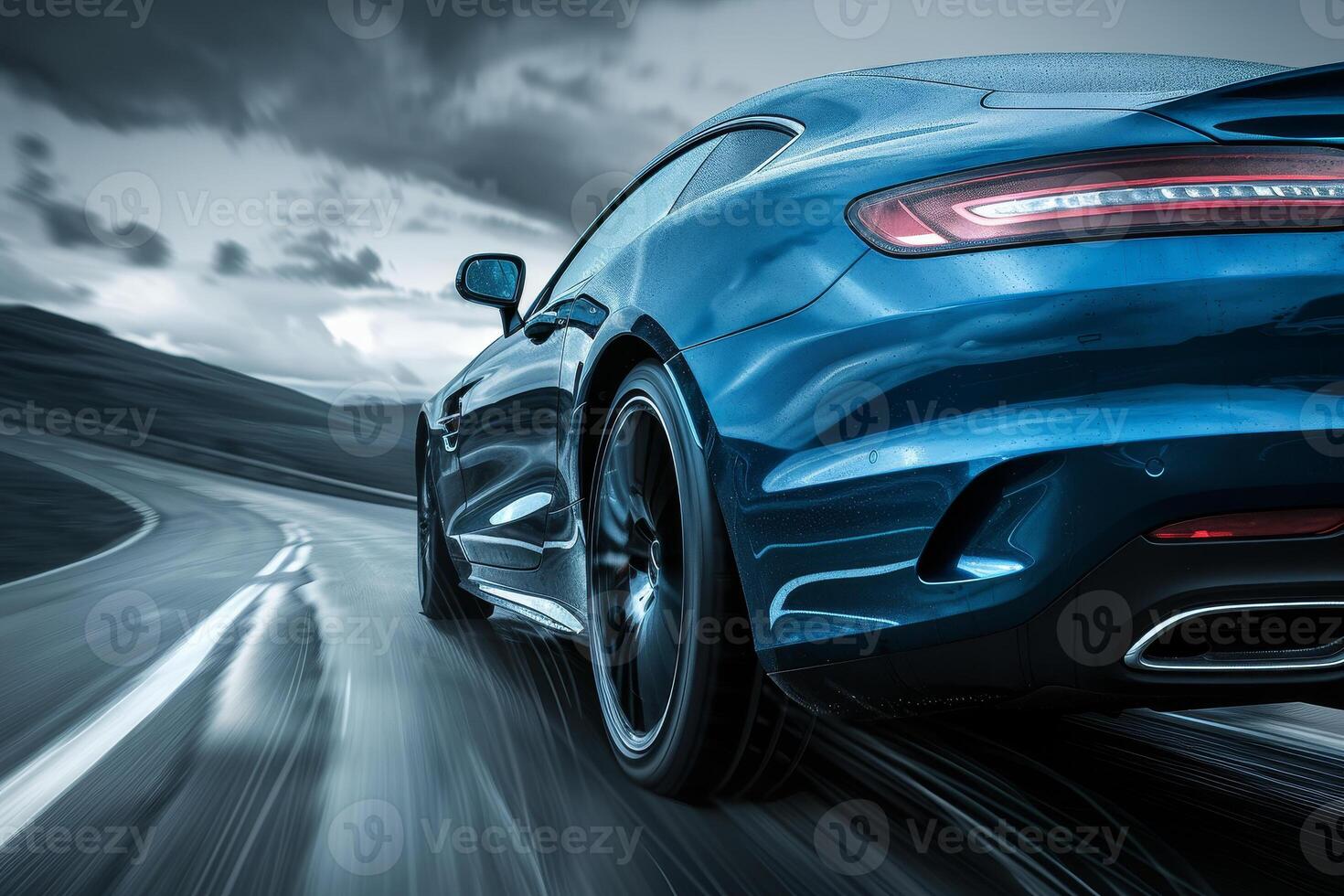 The rear end of a blue sports car driving on a road photo