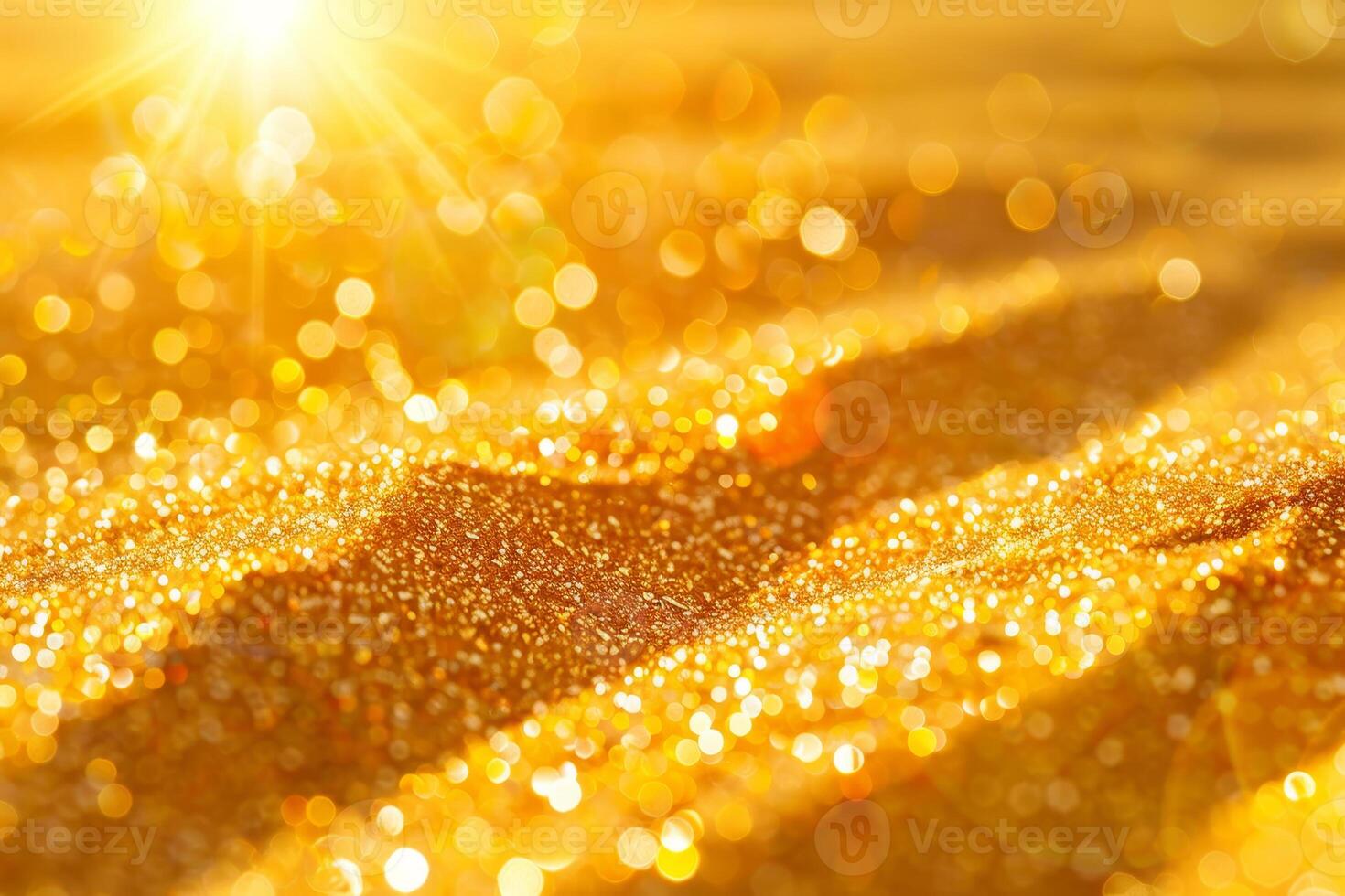 Golden sand background with sun shining through photo