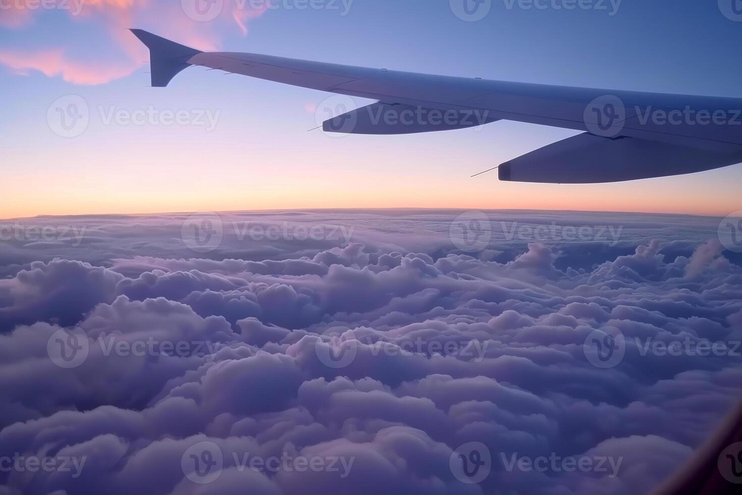 An airplane wing is seen flying over clouds photo