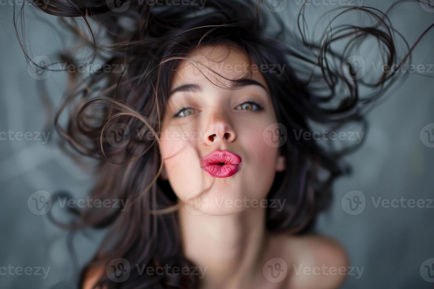 A woman with long hair blowing in the wind photo