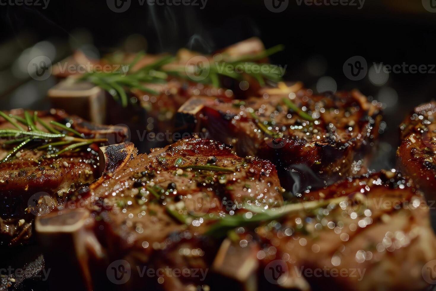 Juicy lamb chops are sizzling on a barbecue grill, infused with rosemary and seasoning, creating an inviting aroma during a summer evening gathering photo