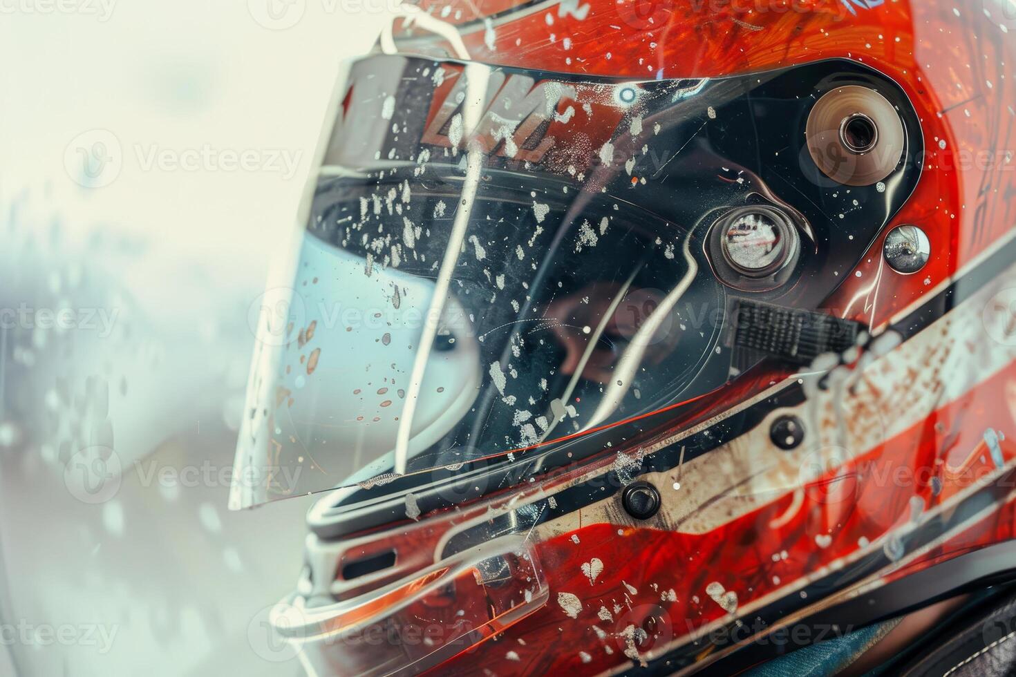 A race car driver helmet glistens with rain droplets while parked on a racetrack, showcasing intricate design and visibility challenges during practice photo