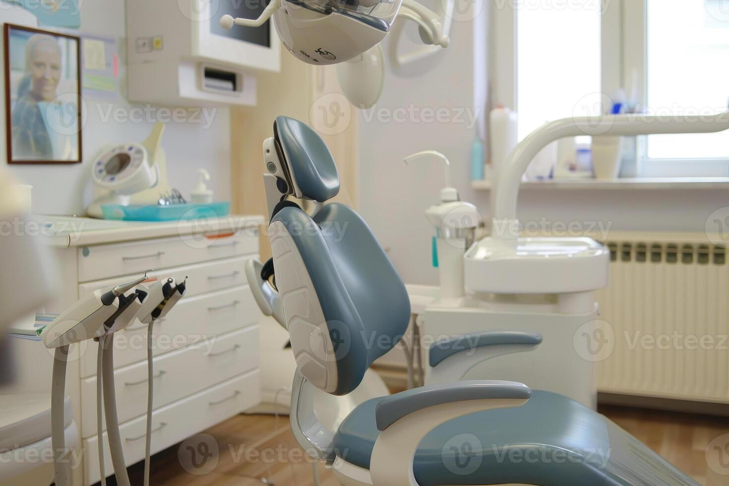The dental office is equipped with contemporary tools, featuring a comfortable chair and various instruments prepared for an upcoming patient appointment photo