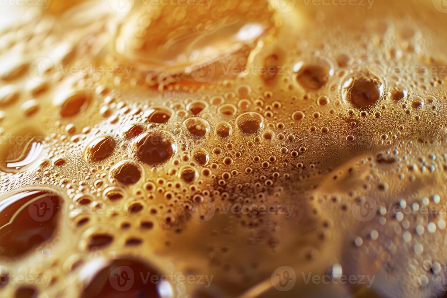 This captivating image captures the texture and bubbles of a golden-brown beverage, illustrating its effervescence and rich color under natural light photo