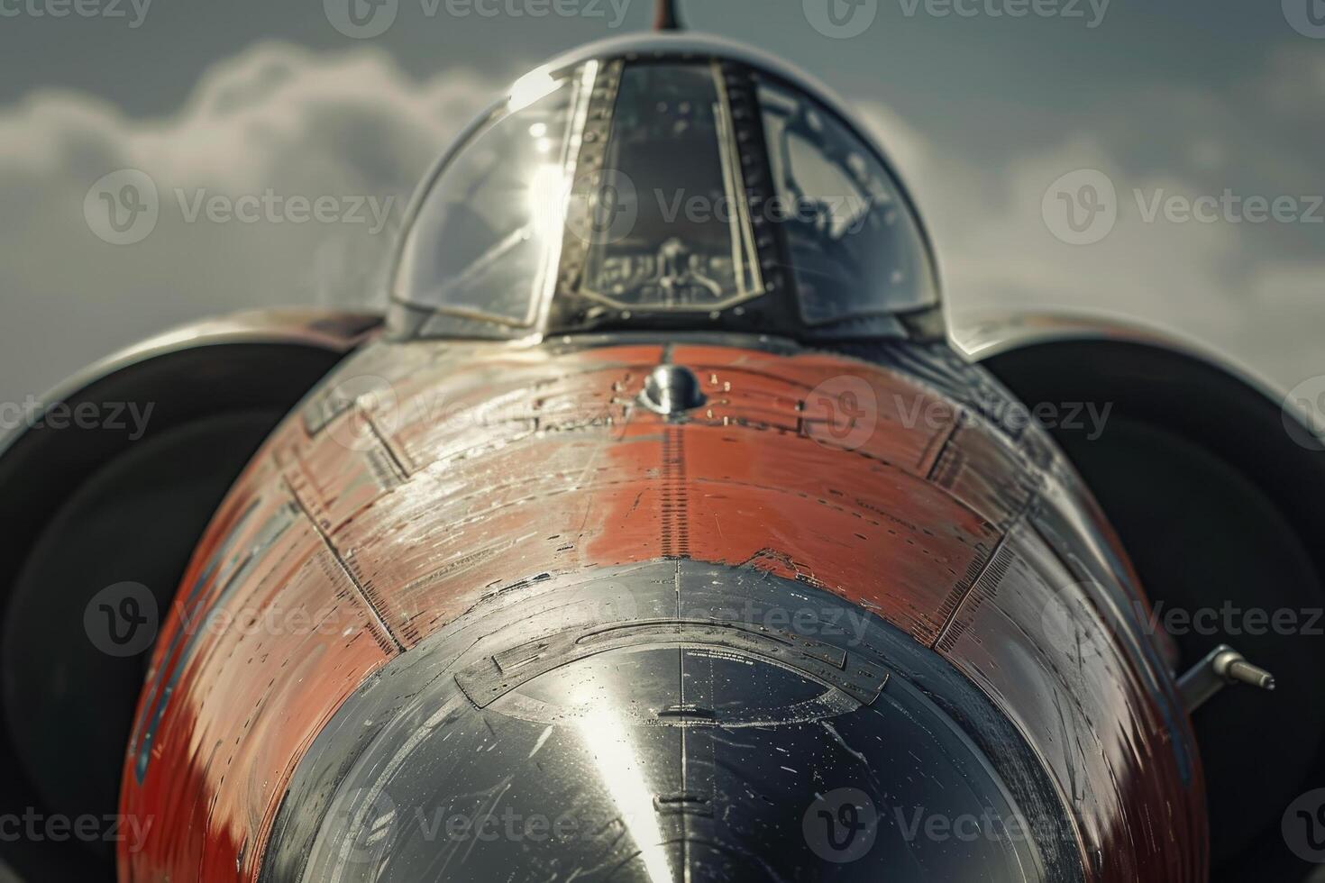 A vintage military aircraft is prominently displayed, highlighting its cockpit and sleek design. The sun reflects off the surface, creating a striking visual against the clouds photo